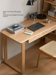 a wooden desk topped with a laptop computer next to a lamp and book shelf filled with books