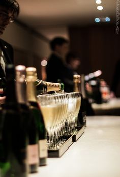 several bottles of wine are lined up on the bar