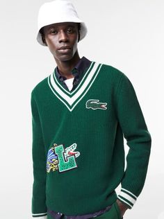 A sporty look. Impeccable details. An iconic design. With extra Lacoste style. Classic fit, comfortable cut: Slightly roomy for the perfect fit. V-neck and striped wrists: Impeccable details. Badge on front: Updated Lacoste style. Crocodile on chest: An XL logo for maximum style. Responsible wool: Keeps you warm. And respects the animals. Wool (100%) Armpit to the armpit is 30 inches Law School Fashion, Lacoste Shop, Mens Holiday, Lacoste Men, The Animals, Sporty Look, Green Sweater, Style Classic, Wool Sweaters