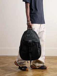 Balenciaga's backpack takes cues from practical hiking styles. It's been made in Italy from durable water-repellent ripstop and embroidered with the brand's 'Unity Sports' logo. It's generously sized to hold a tablet, water bottle and paperback and boasts a host of pockets for keeping the essentials organised. Tom Ford Bag, Balenciaga Backpack, Dagne Dover, Handbag Essentials, Balenciaga Logo, Hiking Fashion, Luxury Sneakers, Stylish Watches, Driving Shoes