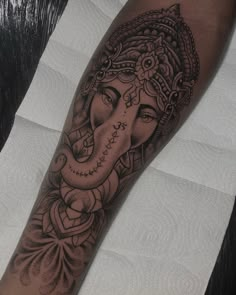 an elephant head tattoo on the arm