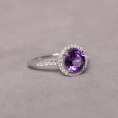 This is a 7mm natural amethyst birthstone ring set in solid sterling silver and with rhodium plated. The ring features a clear round faceted natural amethyst and lots of tiny zircon around of the main stone. If you want other size, please contact me to order and it will take 7-10 days to finish. The item is sent in a beautiful gift box You can realize more lovely stuff clicking the link https://www.etsy.com/shop/knightjewelry?refshopsection_shophome_leftnav Classic Amethyst Ring With Round Cut, Classic Crystal Ring With Birthstone In Round Cut, Silver Amethyst Ring For Anniversary, Classic Crystal Birthstone Ring With Round Cut, White Gold Sterling Silver Gemstones With Round Stone, Classic Round Cut Birthstone Gemstones, Classic Amethyst Diamond Ring With Brilliant Cut, Classic Round Crystal Birthstone Ring, Classic Birthstone In White Gold Setting