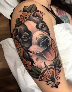 a woman with a tattoo on her arm and dog in the middle of it's arm