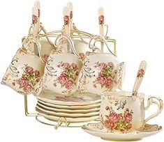 a set of tea cups and saucers with floral designs