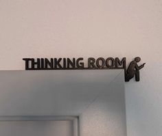 a sign that says thinking room hanging on the wall