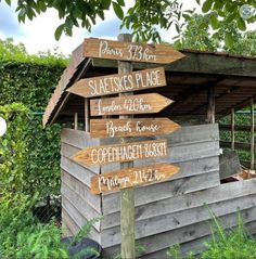 a wooden sign pointing in different directions