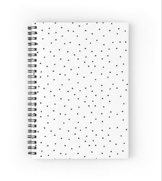 a spiral notebook with black dots on white paper