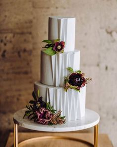 a three tiered white cake with flowers on top