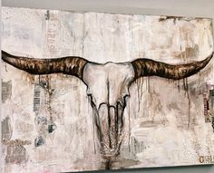 a painting of a bull's skull with long horns on it is hanging on the wall