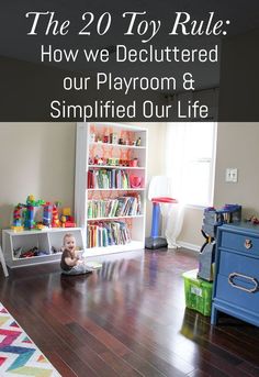 a baby sitting on the floor in front of a book shelf with toys and books