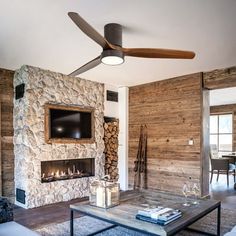 a living room with a fireplace and tv mounted to the wall