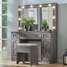 a vanity table with stool and lighted mirror