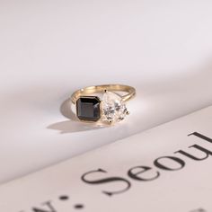 a close up of a ring on top of a book with the word sequin written below it