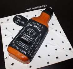 a hot dog in a bottle on top of a cake