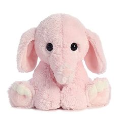 a pink stuffed elephant sitting up against a white background