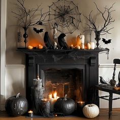 a fireplace decorated with halloween decorations and candles