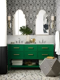 a bathroom with green cabinets and mirrors