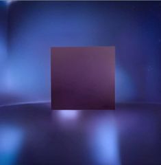 a square object is shown in the middle of a blurry background with blue and purple lights