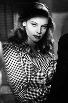 black and white photograph of a woman sitting at a table in front of a man