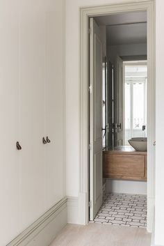 an open door leading to a bathroom with a sink