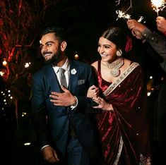 a man and woman are holding sparklers in their hands