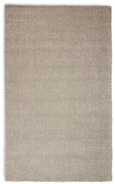 a beige rug on a white background with no one in the room to see it