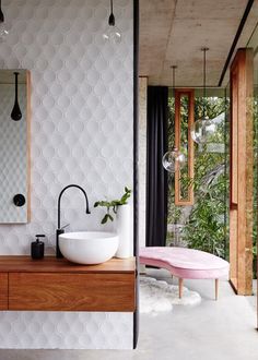 a bathroom with a sink, mirror and bathtub in front of a large window