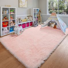 a child's bedroom with pink carpet and toys