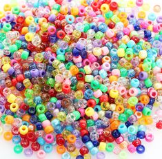 many different colored beads on a white background