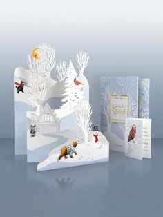 two christmas cards with animals and snowman on them, one in the foreground