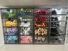 the drawers are filled with many different colored beads