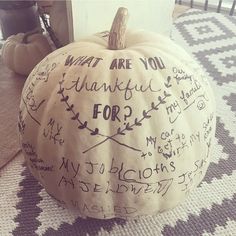 a white pumpkin with writing on it