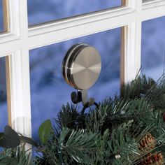 a christmas wreath is hanging on the window sill