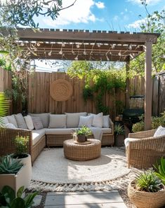 an outdoor living area with wicker furniture and potted plants