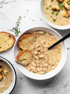 three bowls filled with soup and bread on top of a white countertop next to the words easy crockery garlic bean soup