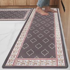 a person is standing on the kitchen floor with their feet in the oven door mat