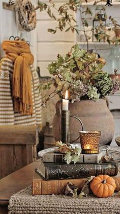 a table topped with lots of books and candles