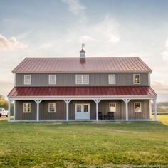 a farm house with a red roof and white trim