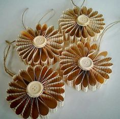 three brown paper flowers with buttons on them