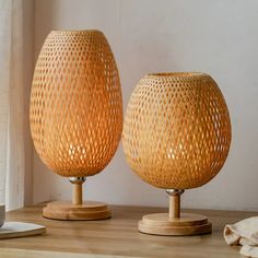 two wooden vases sitting on top of a table