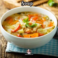 a white bowl filled with soup on top of a blue napkin