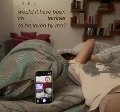 a woman laying in bed with her cell phone