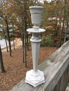 a white lamp post on top of a wooden fence with text overlay reading how to chalk paint a lamp post