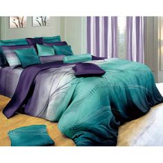 a bed with purple and green comforters on it