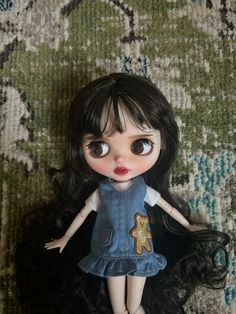 a close up of a doll on a carpet