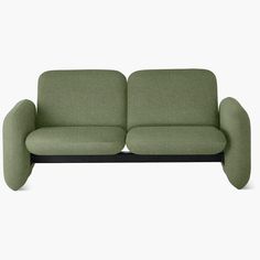 a green couch sitting on top of a white floor