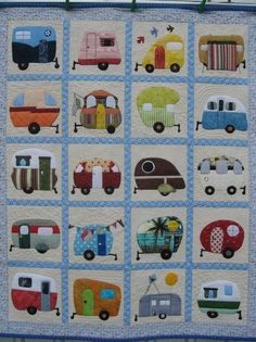 a quilted wall hanging with different types of vehicles on it's sides and in the middle