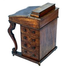 an old wooden desk with drawers and a book on top