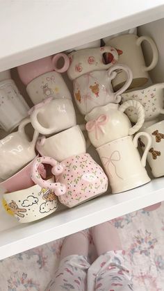 a drawer filled with lots of cups and saucers