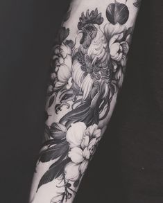 a woman's arm with flowers and leaves on the inside of her forearm, in black and white